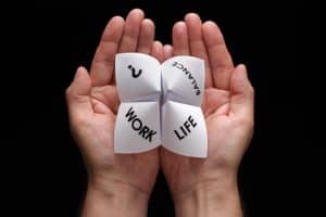 Origami fortune teller in cupped hands concept for work life balance choices